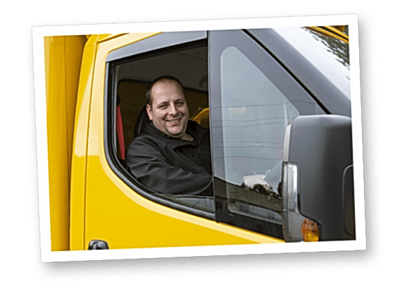 A photograph of an Abel & Cole delivery driver in an Abel & Cole yellow van